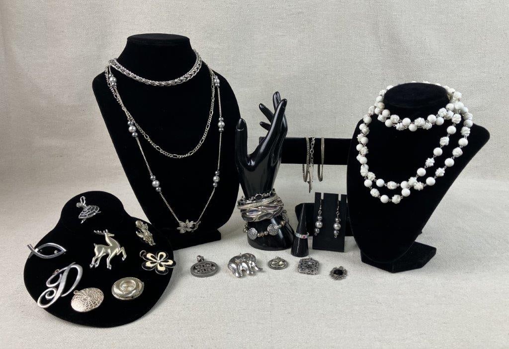 Vintage Silver-Tone Jewelry Including Bradley Watch Pendant: This twenty-seven-piece assortment of vintage silver-tone costume jewelry is highlighted by a Bradley watch pendant featuring a swirling silver-tone frame measuring 1 1/4 in. in diameter (untested).
