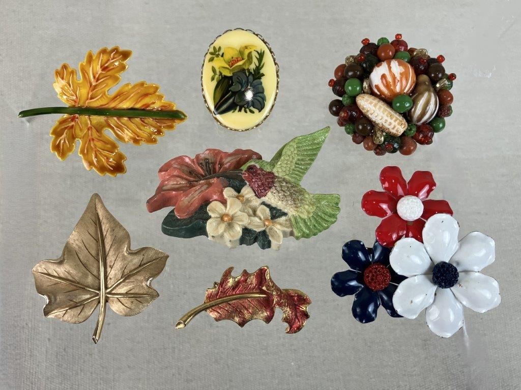 Vintage Brooch Assortment Including Trifari and Robert: This six-piece assortment of vintage brooches features a variety of botanical-inspired designs from celebrated makers, with a focus on leaf motifs. The collection includes a Trifari gold-tone leaf