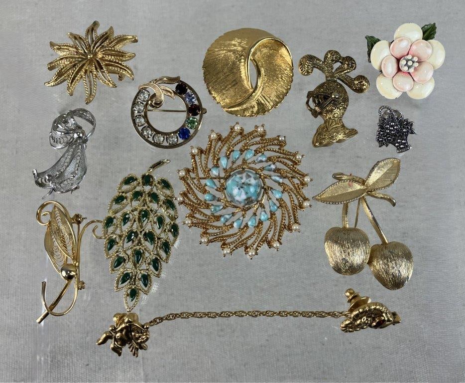 Gold-Tone Costume Brooch Assortment Including Sarah Coventry: This vintage gold-tone brooch collection is highlighted by two distinctive designs from Sarah Coventry, featuring a unique standout piece with two cherry forms and another circular brooch adorned