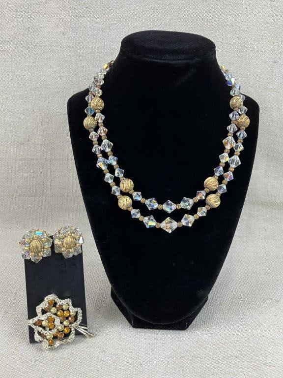 Assortment of Vintage Gold-tone Jewelry: This three-piece collection of vintage gold-tone jewelry features a warm, elegant palette and shimmering textures. The set includes a necklace with clear iridescent rhinestone beads and textured