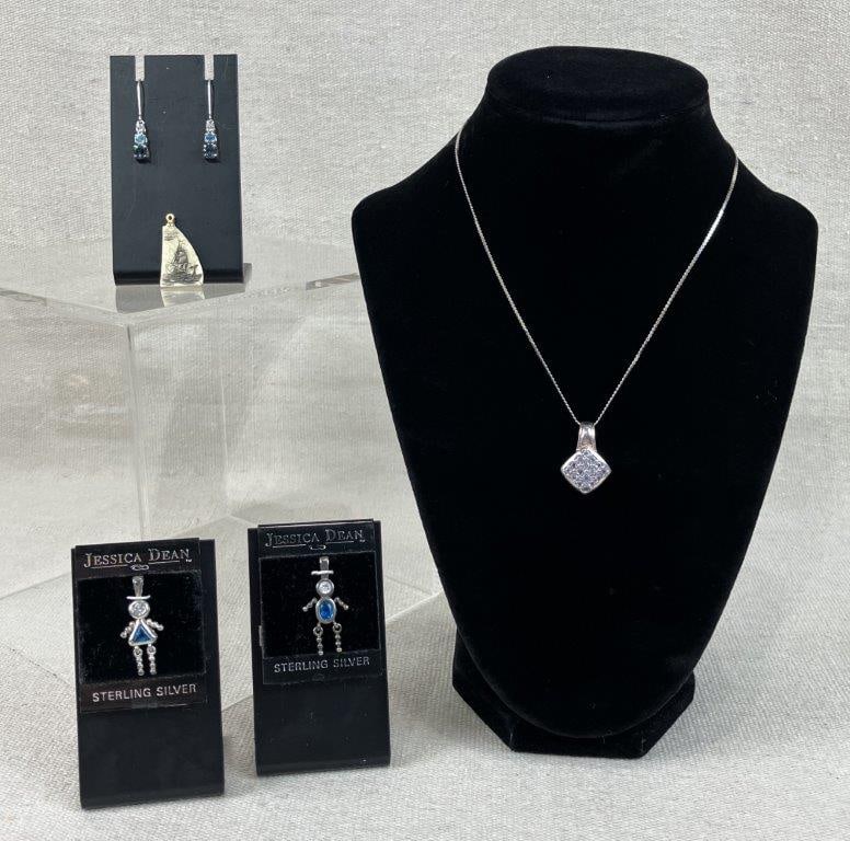 Scrimshaw Pendant with Sterling Silver Jewelry: This five-piece jewelry collection features an eclectic mix of nautical motifs and sparkling silver accents. The assortment includes a scrimshaw pendant featuring an engraving of a sailing ship on