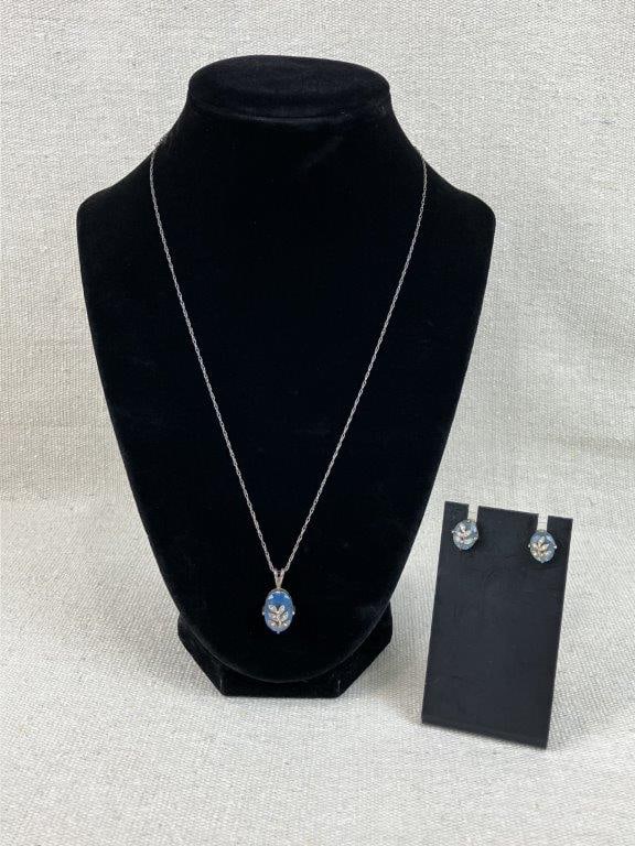 Avon Sterling Silver Blue Topaz Necklace and Earrings: This Avon jewelry set is crafted from .925 sterling silver and features a nature-inspired aesthetic. The necklace showcases an oval-shaped blue topaz centered beneath a leaf overlay accented with