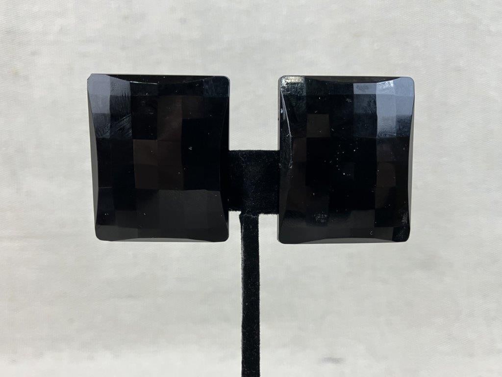 Modernist Mid-Century West German Black Clip-On Earrings: This pair of mid-century modernist clip-on earrings, manufactured in West Germany, features dimensional black acrylic panels with sharp, faceted cuts that create a striking architectural aesthetic.