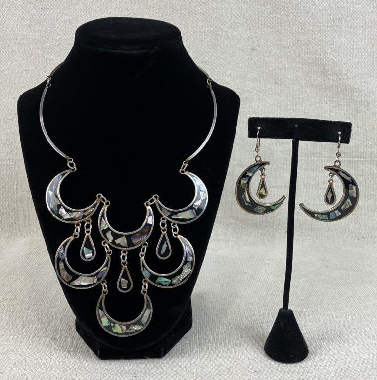 Mexican Alpaca Silver and Abalone Demi-Parure: This striking Mexican alpaca silver demi-parure features a matching necklace and earring set characterized by interconnected crescent moon forms inlaid with iridescent abalone shell and sleek black