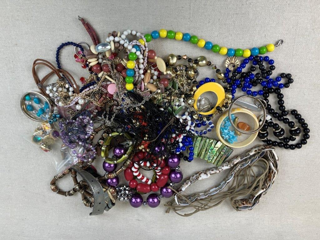 Lot of Vintage and Assorted Costume Jewelry: This diverse jewelry assortment features a mix of vintage and modern pieces, including beaded examples in a variety of gold-tone and silver-tone finishes. The group measures approximately 7 in. H x 8