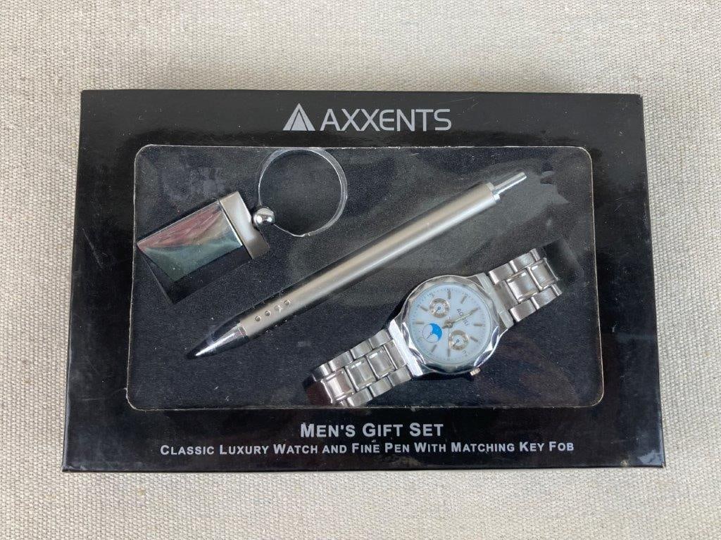 Axxents Men's Gift Set: This men's gift set by Axxents includes a silver-tone metal watch featuring a multi-dial face, a silver-tone fine pen, and a coordinating silver-tone key fob. The presentation box measures