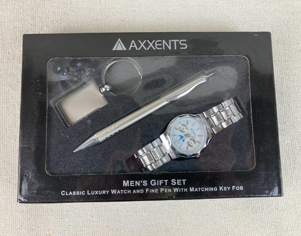 Axxents Men's Gift Set: This men's gift set by Axxents includes a silver-tone metal watch featuring a multi-dial face, a silver-tone fine pen, and a coordinating silver-tone key fob. The presentation box measures