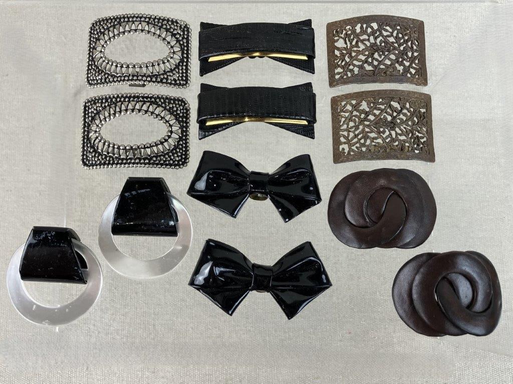 Vintage Shoe Clip Assortment: This vintage shoe clip assortment features a six-piece group, highlighted by a standout silver-tone pair with a reticulated vegetal scrollwork motif in a square frame and a pair of black acrylic bow