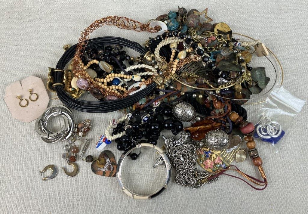 Costume Jewelry Lot: This vibrant costume jewelry lot features a diverse assortment of pieces showcasing intricate beading, shiny gold-tone and silver-tone finishes, and a multitude of colors across a variety of sizes,