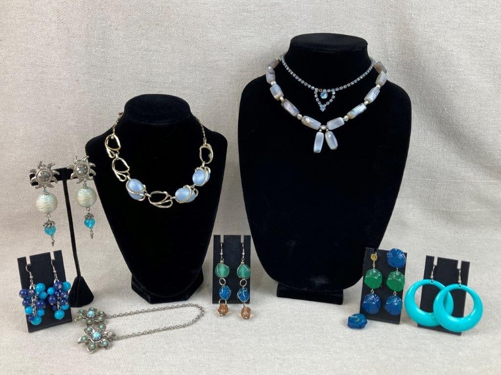 Assortment of Costume Jewelry: This eight-piece lot of costume jewelry features a diverse assortment of vibrant textures and classic vintage styles. The lot includes a pair of slag glass earrings showcasing a distinct blue and