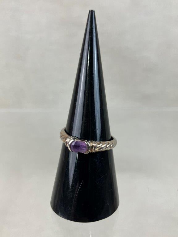 Sterling Silver Amethyst Ring: This sterling silver ring features a classic braided design on the shoulders of the band and is set with an oval amethyst gemstone. The piece is stamped "S925" and is a size 7. It weighs 2.40 grams