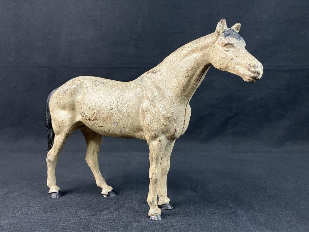 Cast Iron Horse Door Stop: Cast iron horse figurine features a naturalistic depiction with well-defined features and detailed musculature.The piece boasts a beautifully rendered form enhanced by its original polychrome painted