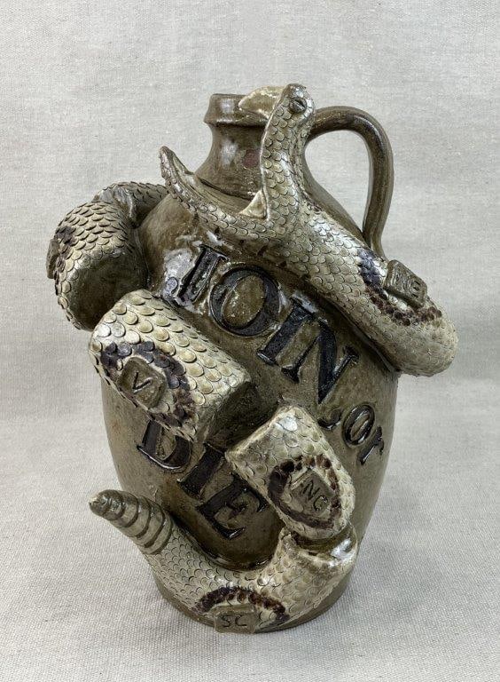 Clint Alderman Snake Jug: This exceptional folk art jug by acclaimed regional potter Clint Alderman depicts a striking copperhead snake encircling the circumference of the vessel over a traditional green alkaline glaze.