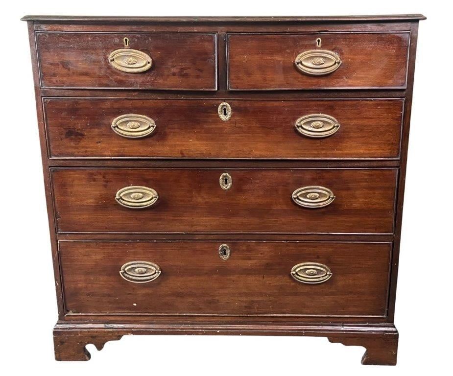 19th Century English Mahogany Chest: A handsome 19th century English mahogany chest featuring a molded edge top and a two over three drawer configuration, resting on shaped bracket feet. The piece displays good proportions and classic