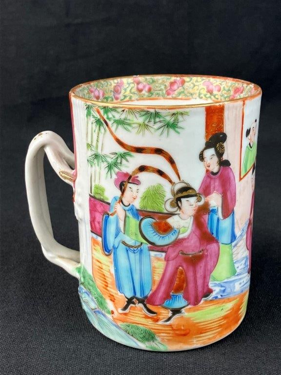 Chinese Famille Rose Mug: Chinese porcelain mug is beautifully adorned with a vibrant famille rose figurative narrative motif, masterfully depicting intricately dressed figures within a traditional domestic setting. The