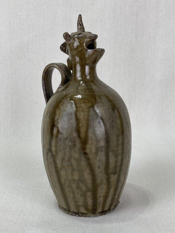 Bob Armfield Stoneware Unicorn Pitcher: Hand-crafted in 1999 by North Carolina ceramicist Robert "Bob" Armfield, this stoneware pitcher is a distinctive piece of Southern folk art. The design features a functional pouring spout sculpted
