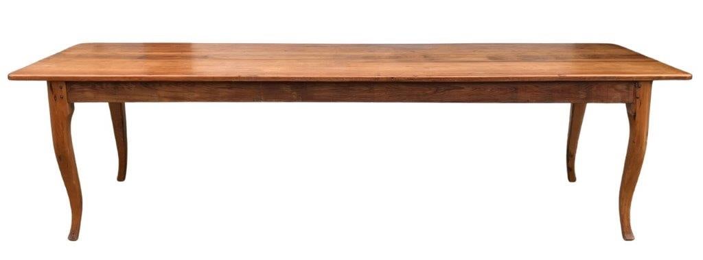 Large French Country Pine Farm Table: An impressive French Country farm table of substantial size, constructed in pine with a warm tone and handsome grain displayed across the thick top. The table comfortably seats ten and is supported