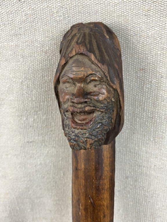 Figural Black Americana Page Turner: A striking figural page turner features a lively, expressive bust of a laughing, bearded African American man, exhibiting expert folk artistry and natural carving skill. The intricately detailed