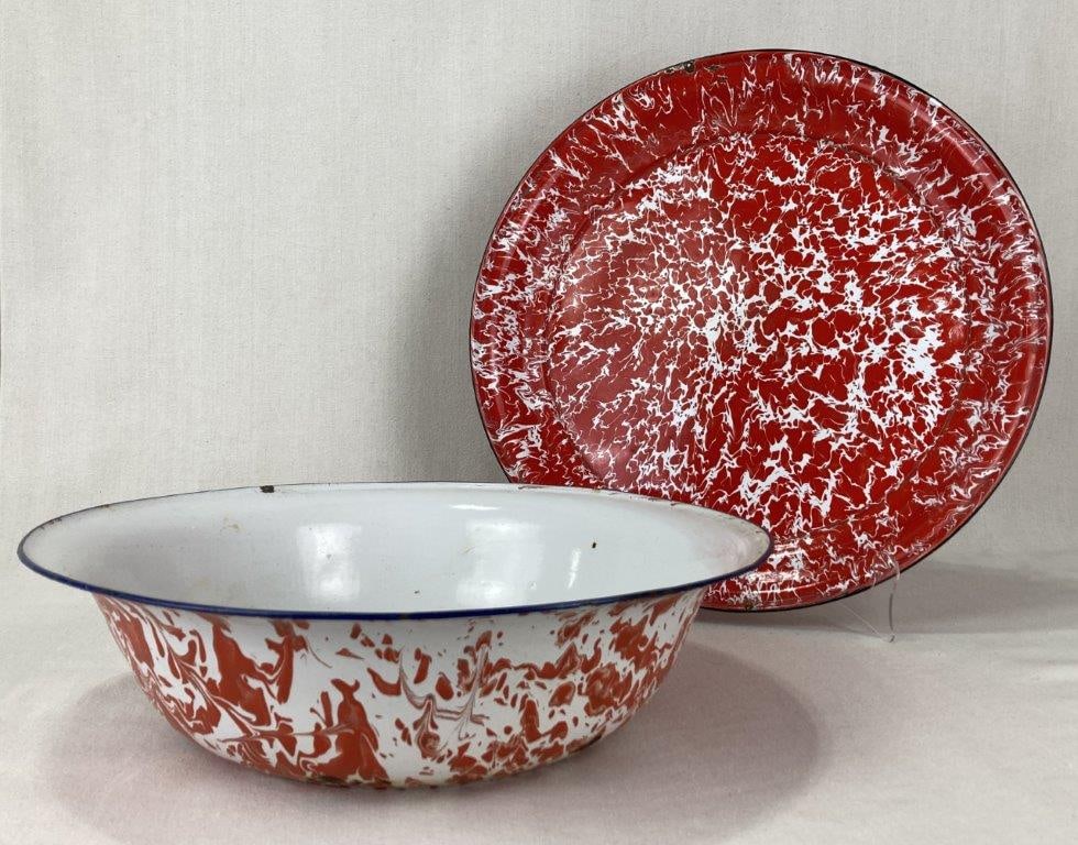 Red Swirl Graniteware Bowl and Tray: A red and white swirl graniteware bowl and round tray. The tray features a more vibrant red swirl design, while the bowl displays a dark blue rim and the tray a black rim. Both pieces show a worn
