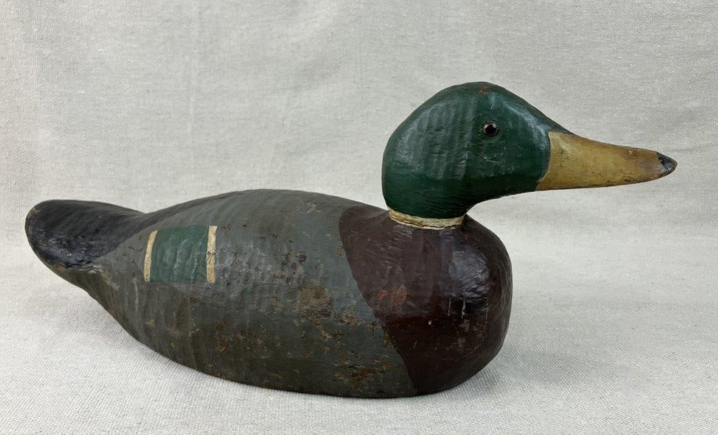 Mallard Duck Decoy: Striking hand-carved mallard duck decoy showcases exceptional artistry, featuring detailed polychrome painted plumage that beautifully replicates the iconic markings and rich coloration of the
