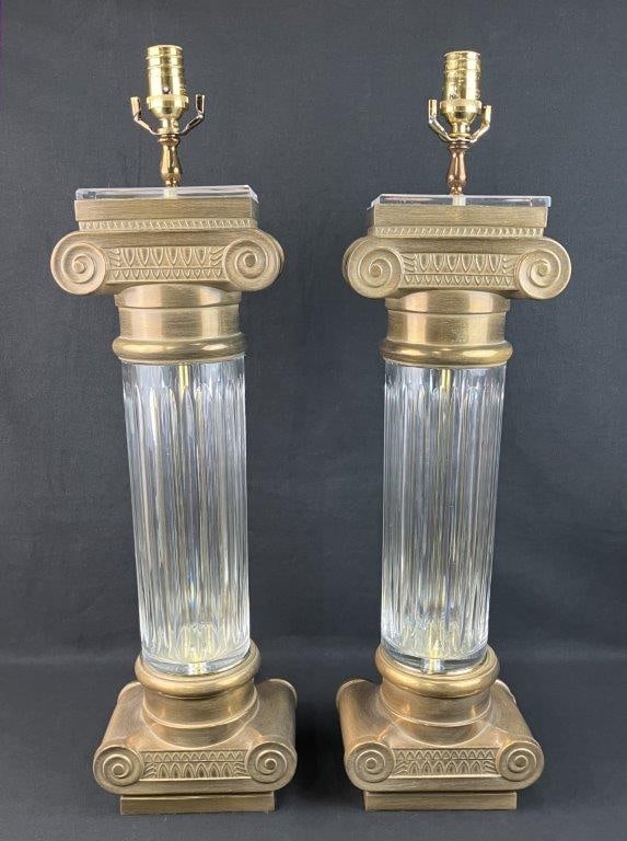 Pair of Neoclassical Style Brass and Glass Columnar Lamps: This striking pair of Mid-Century Modern Neoclassical style lamps by Design Guild beautifully blends architectural grandeur with vintage sophistication. Each lamp features an elegant, clear glass flut