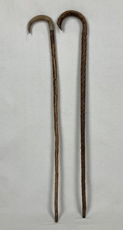 Two Organic Form Canes: Two distinctive wood canes showcasing organic forms and varied wood textures. One features a rugged, natural grain with a naturally curved horn handle. The other displays a knobby, highly textured