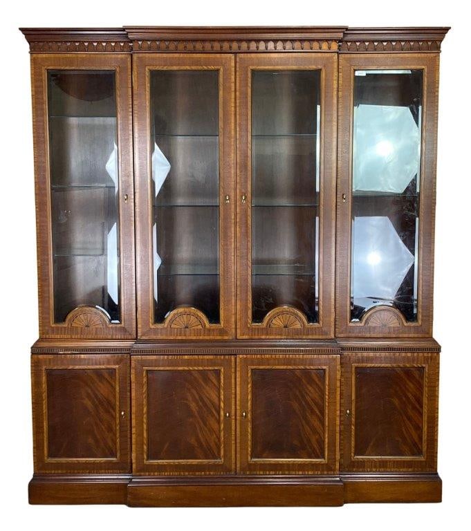 Regency Style Flame Mahogany Breakfront Bookcase: An exceptional Regency style flame mahogany breakfront bookcase crafted with striking figured veneers and elegant classical detailing throughout. The upper case features four cabinet doors opening to 
