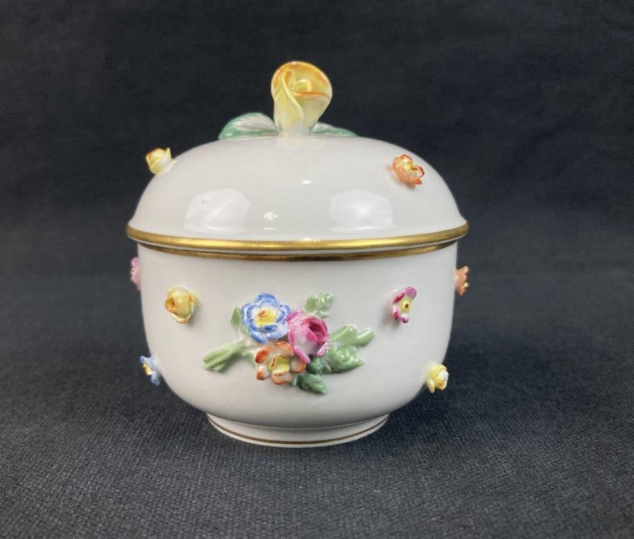Meissen Porcelain Flower-Decorated Covered Box: This early 19th Meissen porcelain covered box features a crisp white porcelain form beautifully adorned with delicate applied floral decorations. The piece bears a period-accurate maker's mark to the