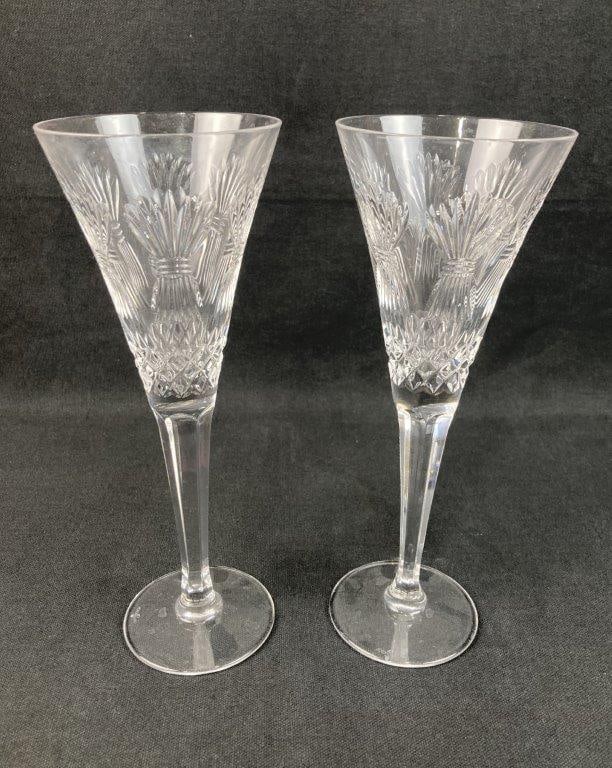 Pair of Waterford Millennium Prosperity Champagne Flutes: This pair of Waterford crystal champagne flutes is from the celebrated Millennium Series, showcasing the Prosperity toast design characterized by its beautiful cut-crystal wheat motif and crisp