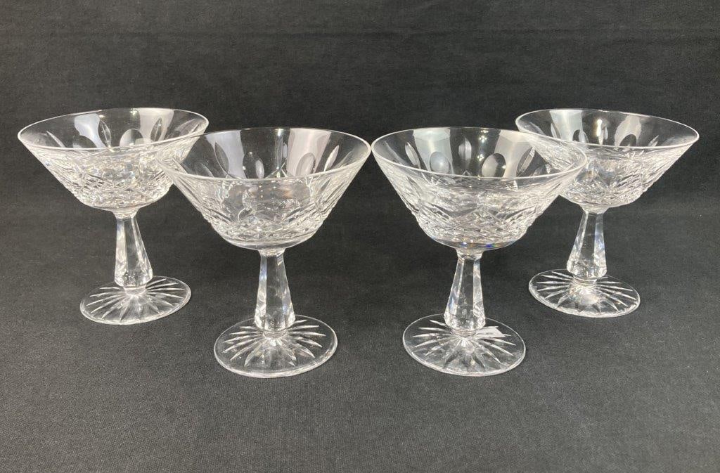 Four Waterford Kenmare Tall Sherbet Glasses: This set of four Waterford tall sherbet glasses is crafted in the beautifully cut Kenmare pattern, featuring elegant forms and brilliant cut-crystal details. Each glass measures approximately 4 3/4
