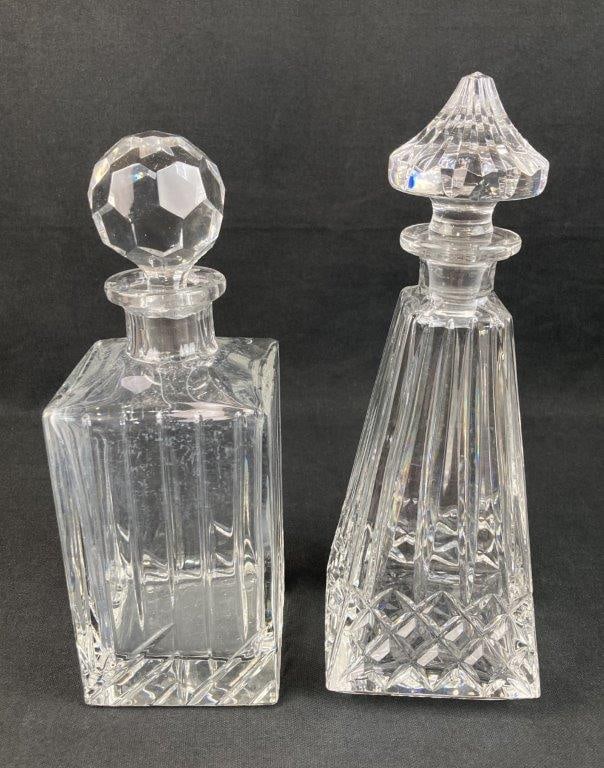 Waterford and Rogaska Crystal Decanters: This group of crystal decanters features exceptional prismatic cut glass work by classic makers, each complete with a coordinating stopper. The tallest decanter, by Waterford in the Lissadel pattern, 