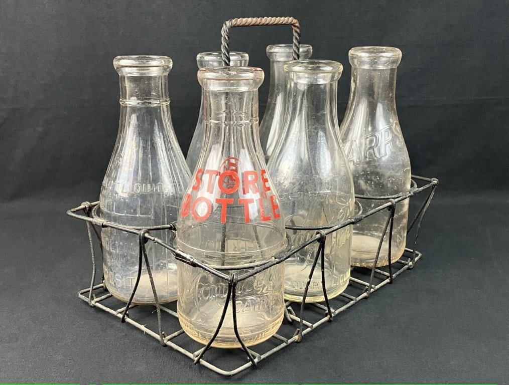 Glass Milk Bottles with Carrying Basket: This nostalgic collection features a vintage wire carrying basket accompanied by six glass bottles of various makes, originally used for traditional milk transport. The assortment showcases classic,