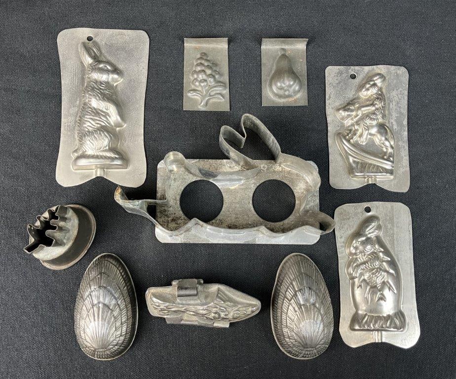 Assortment Tin Candy Molds: A charming nine-piece assortment of antique tin candy molds captures the nostalgic appeal of traditional confectionery craftsmanship. The collection features a delightful variety of shapes and