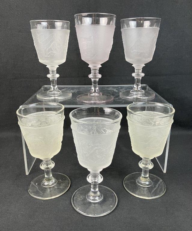 Six L.G. Wright Westward Ho Water Goblets: Six pressed glass water goblets, dating to circa 1930, including one with amethyst coloration, beautifully captures the nostalgia and pioneering spirit of the historic 19th-century frontier motif, as