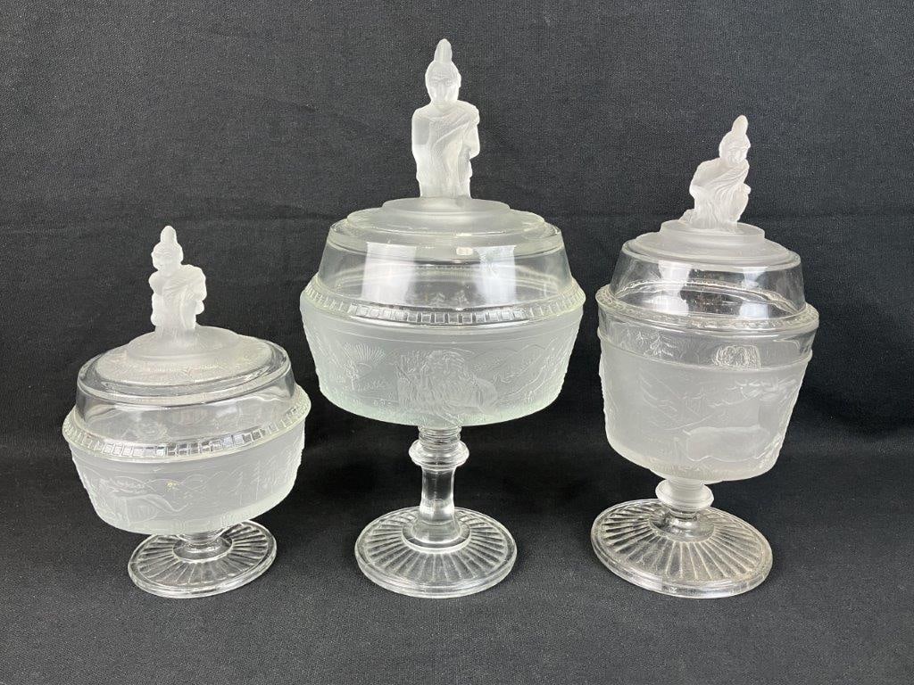 Three-Piece Assortment L.G. Wright Westward Ho Covered Glass Tableware: Striking trio of pressed glass pieces, dating to circa 1930, beautifully captures the nostalgia and pioneering spirit of the historic 19th-century frontier motif, as successfully revived by the L.G.