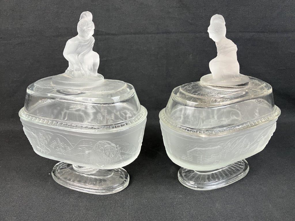 Two L.G. Wright Westward Ho Covered Oval Compotes: Two pressed glass pieces, dating to circa 1930, beautifully captures the nostalgia and pioneering spirit of the historic 19th-century frontier motif, as successfully revived by the L.G. Wright Glass