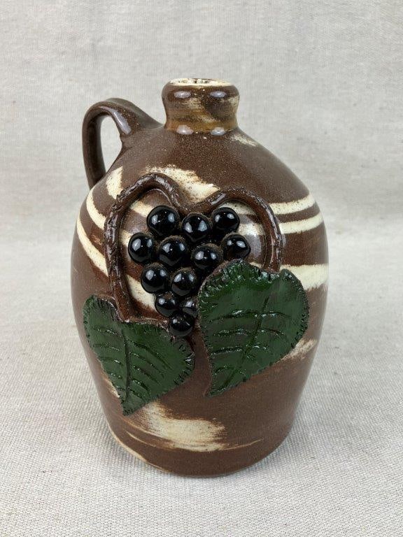 Johnathan Ervin Grape and Vine Swirl Pottery Jug: This exceptional folk art pottery jug by regional artisan Johnathan Ervin features an elegant swirl design glaze accented by a detailed, hand-applied grape and vine relief design. Ervin began his