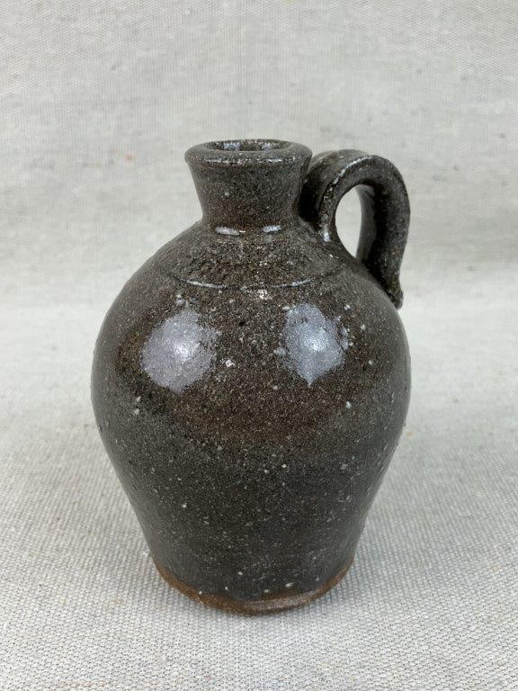 North Carolina Studio Pottery Jug: This charming piece of regional North Carolina studio pottery features a soft grey speckled glaze covering a gracefully curving form. Hand-thrown in the historic pottery community of Seagrove, NC,
