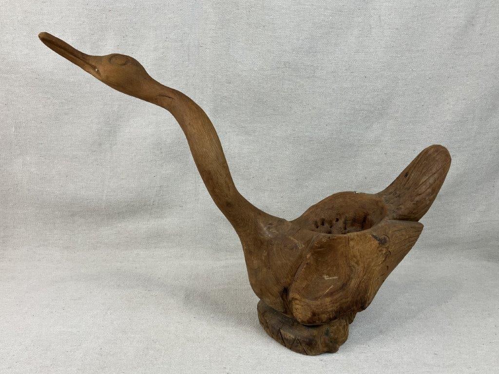 Folk Art Hand-Carved Bird: Captivating piece of regional folk art features a graceful figural birdâ€”evoking the elegant, elongated silhouette of a swan or wild waterfowlâ€”masterfully