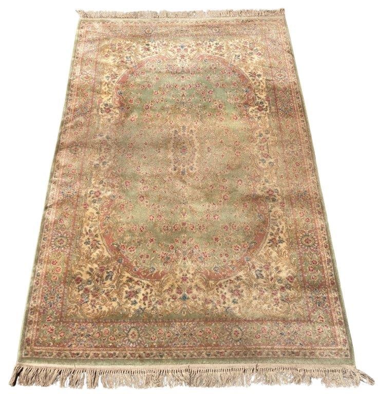 Karastan Wool Rug: A wonderful green Karastan wool rug. It measures approximately 116 inches x 69Â¼ inches. Some discoloration consistent with age and use.