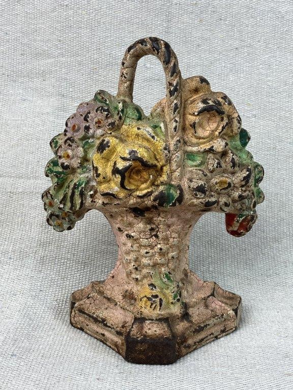 Hubley Cast Iron Basket of Roses Doorstop: A Hubley cast iron doorstop in the form of a basket of roses, retaining old paint with a nice weathered patina. It measures approximately 5Â½ inches high x 4Â½ inches wide x 1Â