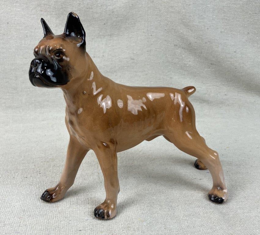 Porcelain Boxer Dog Figurine: Porcelain figurine captures a Boxer dog with expert artistry, showcasing a deep, naturalistic understanding of the breed's distinctive anatomy and alert features. Rendered in a dynamic, active