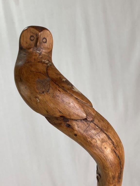 Folk Art Carved Owl Cane: This hand-carved wooden cane features an owl motif handle and an incised "WC" monogram with the year 1985 just below. The piece displays a warm patina. Measuring approximately 43 1/2 in. L x 4 1/4