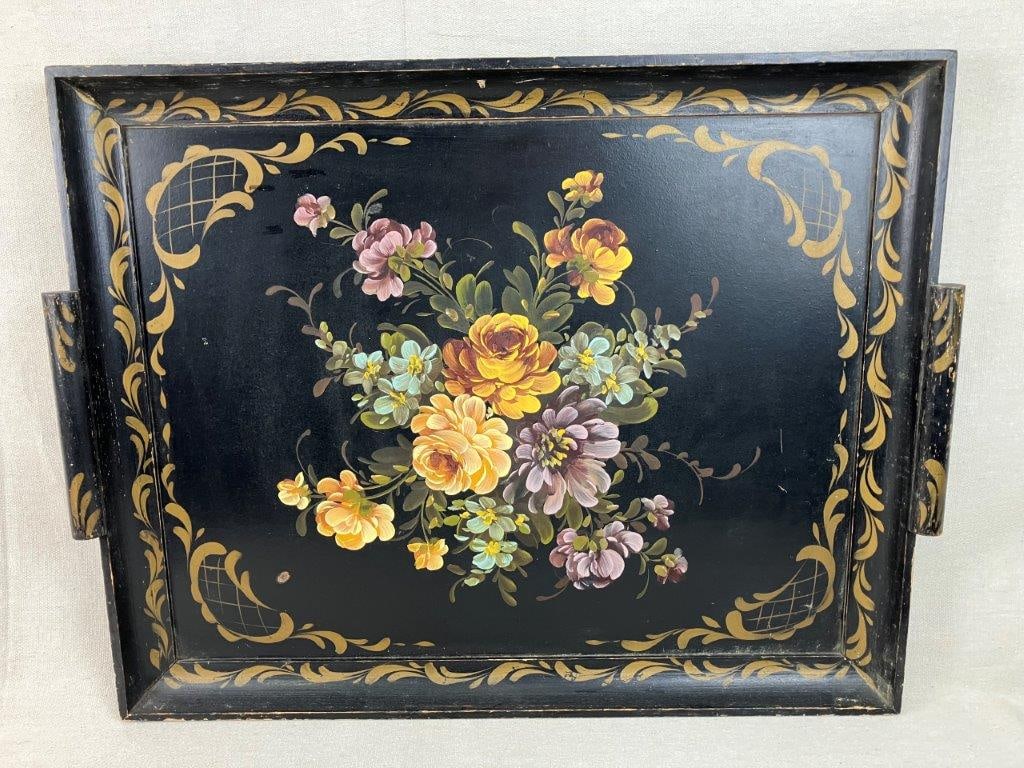 Large Painted Wood Floral Tray: A large and decorative painted wood tray featuring a striking black background with a vibrant central bouquet of roses. The tray is further enhanced with elegant gold stenciled decoration along the