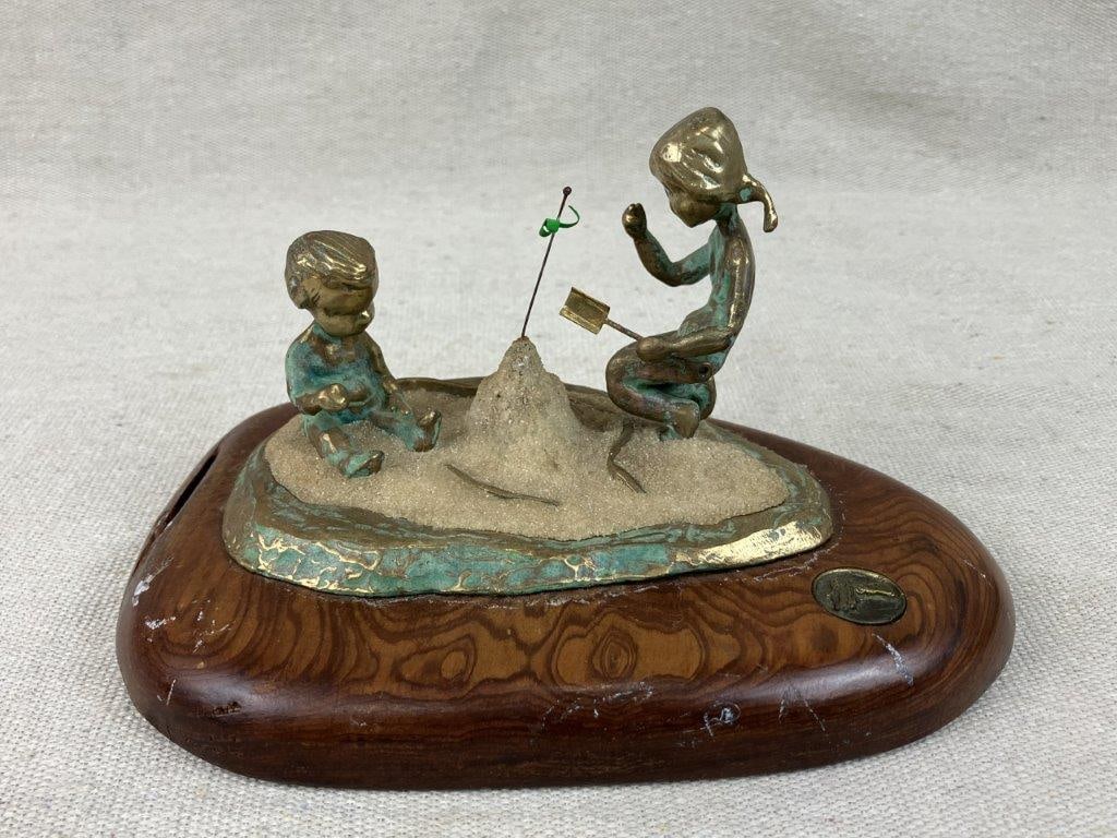 Malcolm Moran Bronze Sculpture of Children Building a Sandcastle: Charming 1972 bronze sculpture by celebrated artist Malcolm Moran captures a nostalgic and tender slice of youth, beautifully depicting two children intently building a sandcastle on the beach.