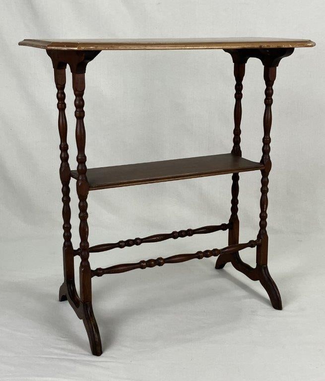 Walnut Stand: A 20th century walnut stand featuring turned legs and a shaped top with a central shelf. The piece displays clean lines and practical design with attractive walnut grain. Measures approximately 28