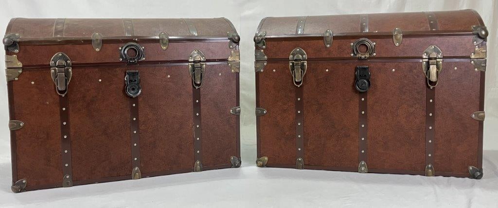 Pair of Faux Leather Dome Top Trunks: This handsome set of two dome-top trunks features a warm brown faux leather finish accented by dark metal hardware, rounded corner bumpers, and classic flip-down latches with leather strap handles on
