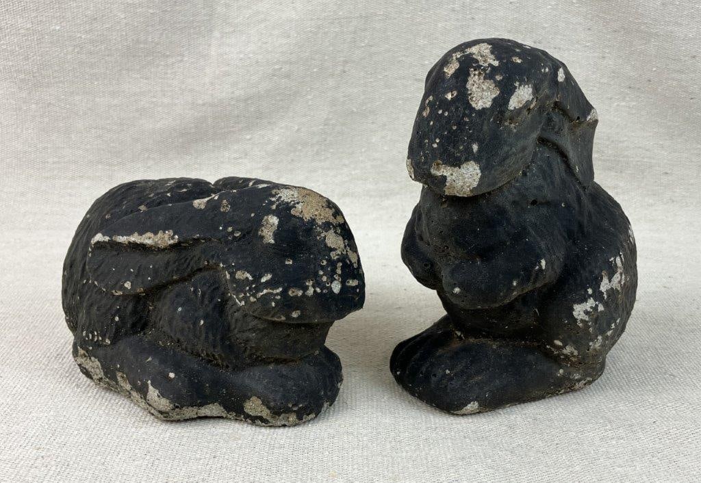 Pair of Cast Concrete Painted Rabbits: This delightful pair of rabbit sculptures features a striking black painted finish layered over sturdily cast concrete forms. Showcasing a whimsical yet classic design, these charming figures boast