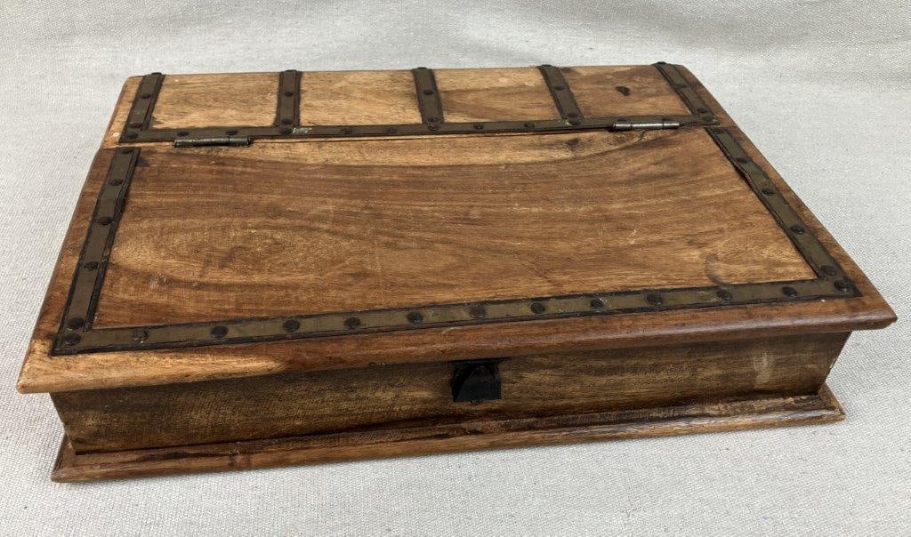 Pinewood Storage Box: This handsome pinewood storage box features a practical hinged top and is distinctively adorned with industrial metal bands fastened by prominent rivets, injecting a warm, rustic flair into the