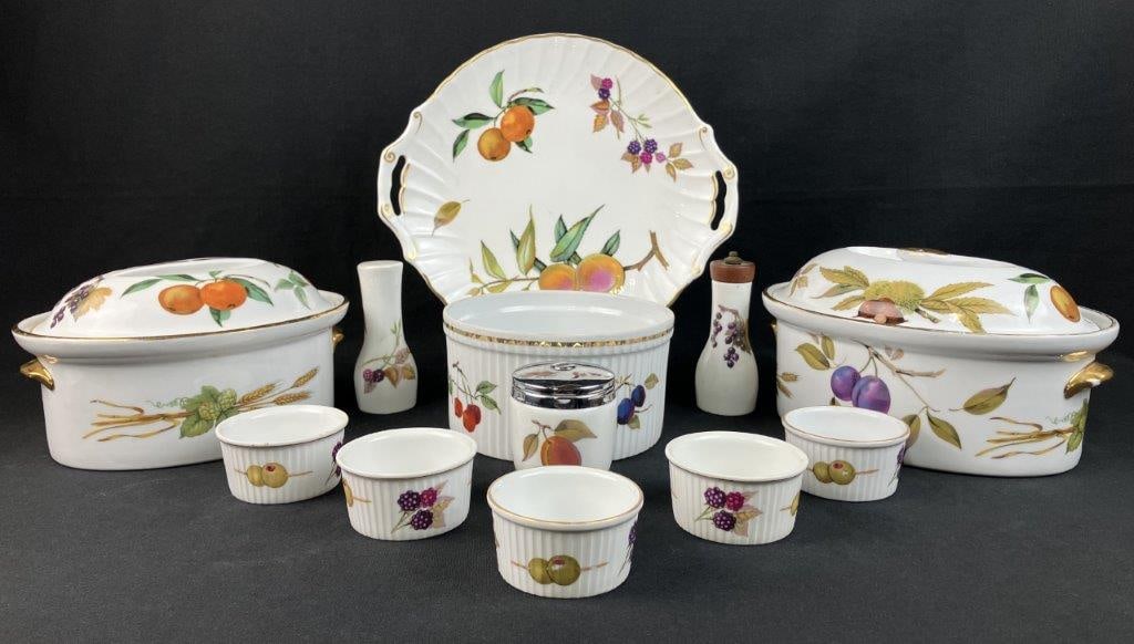 Royal Worcester Evesham Porcelain Dishware: This twelve-piece collection of fine English porcelain by Royal Worcester primarily features the maker's classic, fruit-themed "Evesham" pattern, complemented by a single cake plate in the hawthorn-th